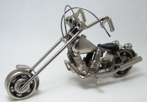 Made from recycled metal parts. Wheels turn. Chrome like oiled finish 